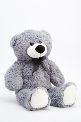 grey teddy bear with patches